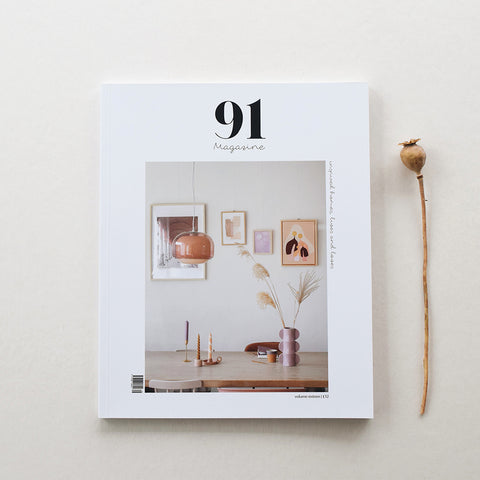 91 Magazine Issue 16 is an independent interiors and lifestyle magazine. Magazine on table with seed head.