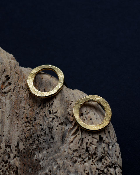 Handmade gold vermeil stud earrings with a matt hammered surface inspired by textures found in the natural world.
