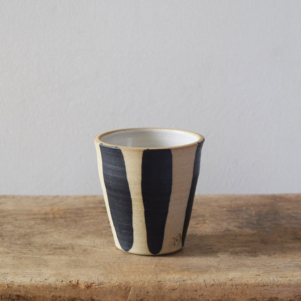 Handmade Windmill Pottery ceramic beaker with a white and cobalt glaze. This beautiful beaker is perfect for coffee, water or whatever you fancy. Made in Sussex from stoneware clay by ceramicist Anna Sandberg.