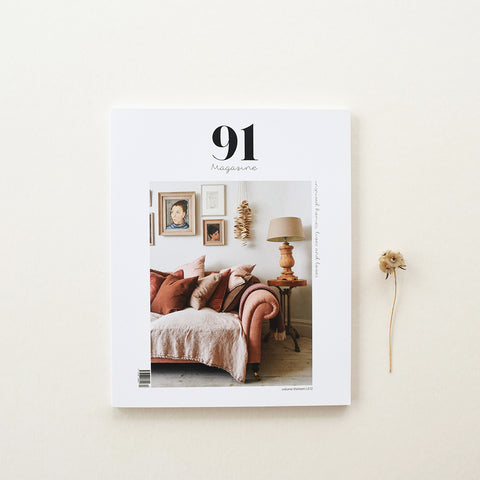 91 Magazine Issue 13 is an independent interiors and lifestyle magazine. Magazine on table with seed head.