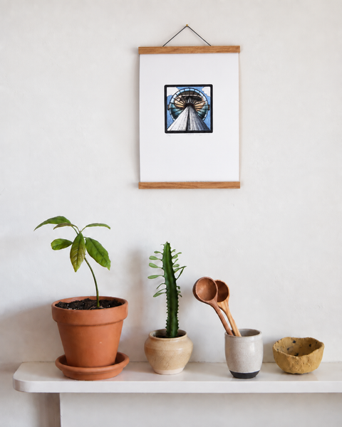 Brighton i360 fine art print displayed on a wall with plants and handmade homeware