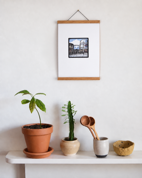Churchill Square Brighton fine art print displayed on a wall with plants and handmade homeware