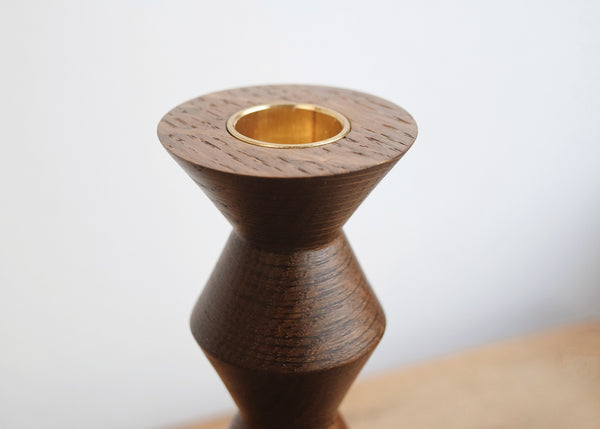 Close-up of the solid brass candle insert on a fumed oak candlestick