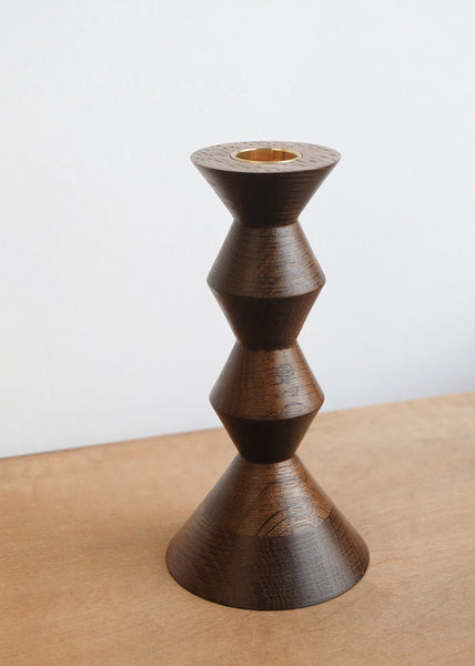 Side view of the sculptural stacked design of a handmade fumed oak candlestick