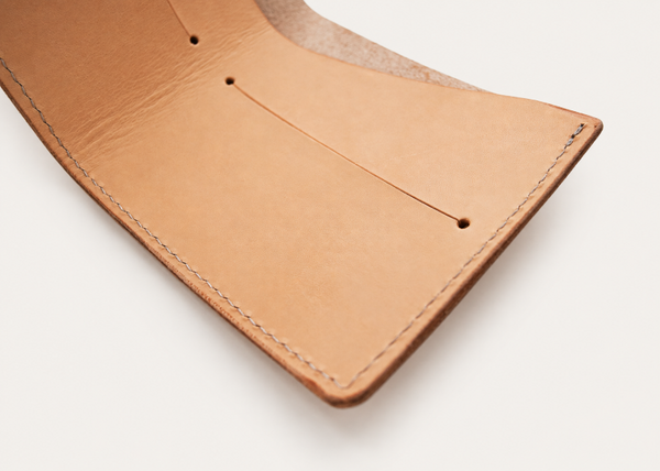 Inside view of a natural leather billfold wallet showing two card slots and note area