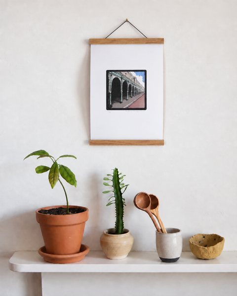 Madeira Terrace Brighton fine art print displayed on a wall with plants and handmade homeware