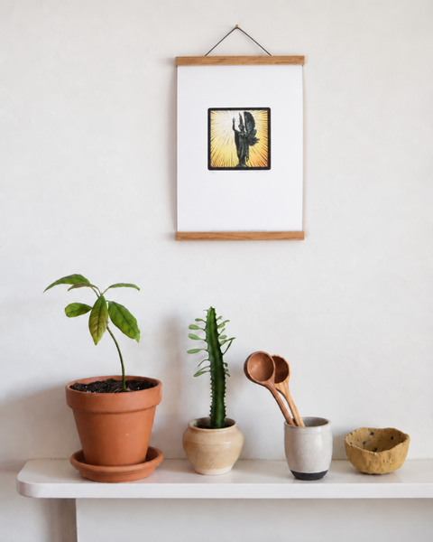 Peace Statue Brighton fine art print displayed on a wall with plants and handmade homeware