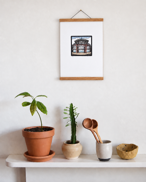 Shelter Hall Brighton fine art print displayed on a wall with plants and handmade homeware