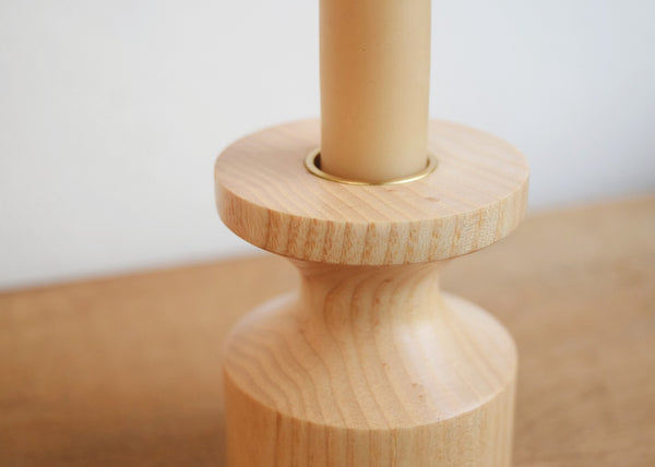 Detail of handmade ash candlestick with solid brass insert