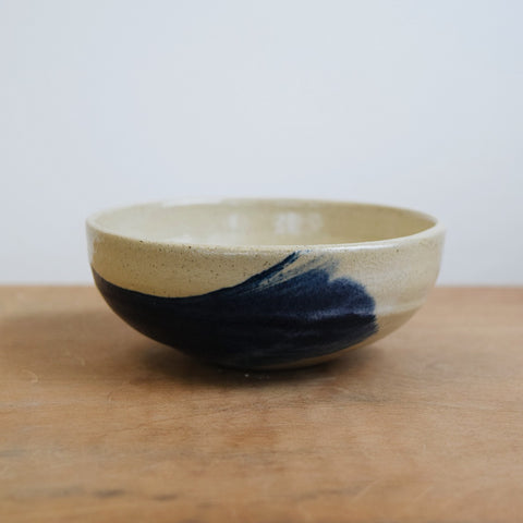 Small hand-thrown ceramic bowl with white and indigo cobalt glaze