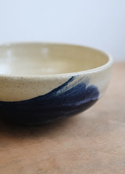 Hand-thrown small ceramic bowl with a white and cobalt glaze by Windmill Pottery. This beautiful bowl is a perfect size for olives, nuts, dips or other snacks. 