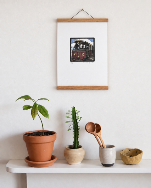 Volk's Electric Railway Brighton art print displayed on a wall with plants and handmade homeware
