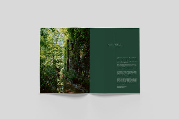 Open pages from Bloom Issue Seven featuring a woodland stream and nature-inspired editorial