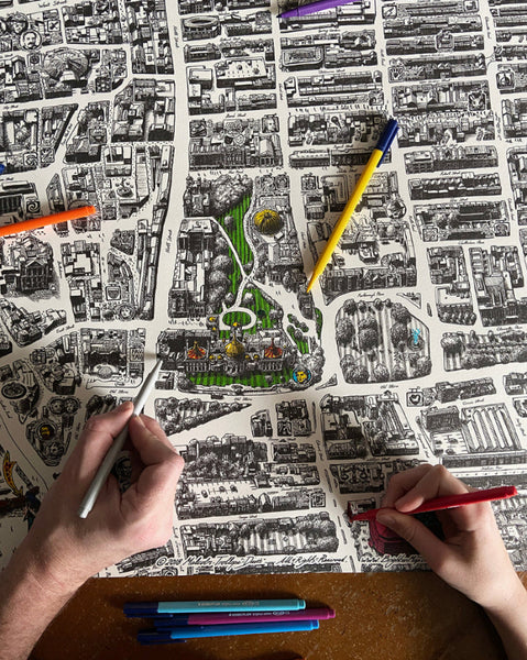 Adults and children colouring the hand-drawn Brighton Map poster together