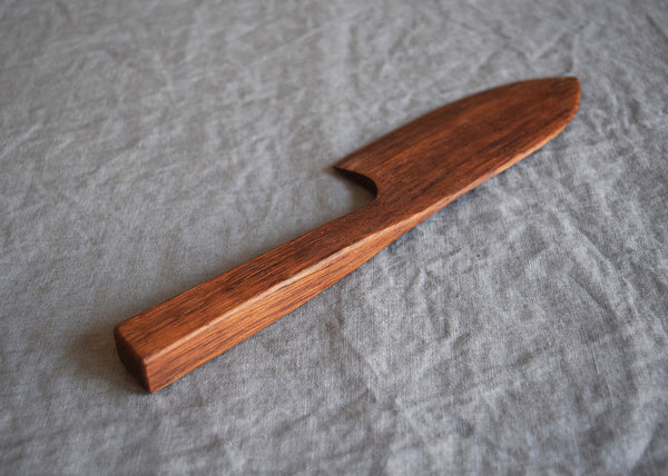 Handcrafted Brown Oak cake knife by Selwyn House on a linen cloth
