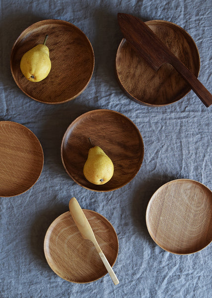 Brown Oak cake knife displayed with wooden bowls and pears on a linen tablecloth