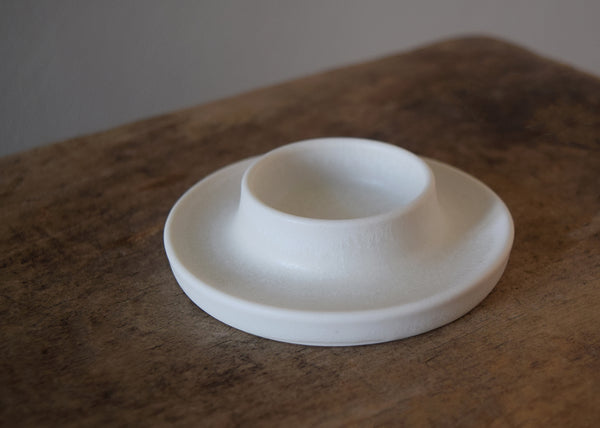 Ceramic candle holder handmade by Katie Robbins in a studio in Birmingham. Each porcelain candle holder is wheel thrown and finished with a matt white glaze. Perfect with our pure beeswax candles!
