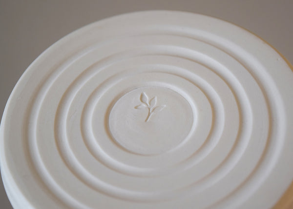 Ceramic candle holder handmade by Katie Robbins in a studio in Birmingham. Each porcelain candle holder is wheel thrown and finished with a matt white glaze. Perfect with our pure beeswax candles!