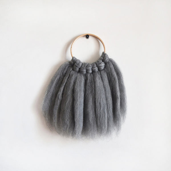 Mini woven wall hanging, designed and handcrafted in the UK from ethically sourced pure merino wool in grey. 
