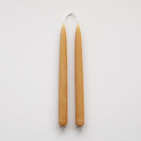 Pair of hand-dipped English beeswax taper dinner candles with a natural golden colour and warm glow