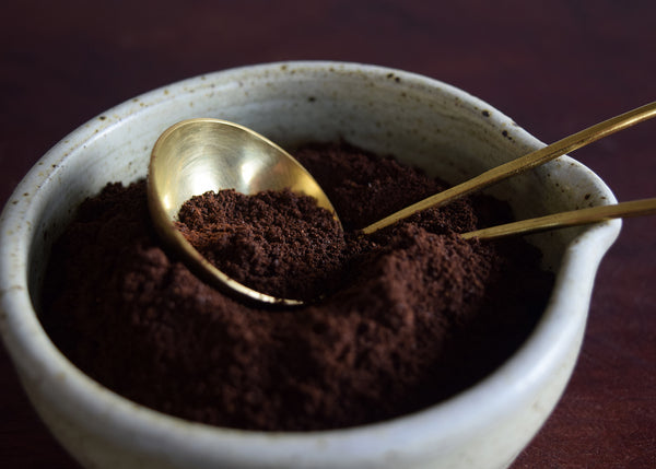 Handmade brass and silver coffee scoop measuring ground coffee