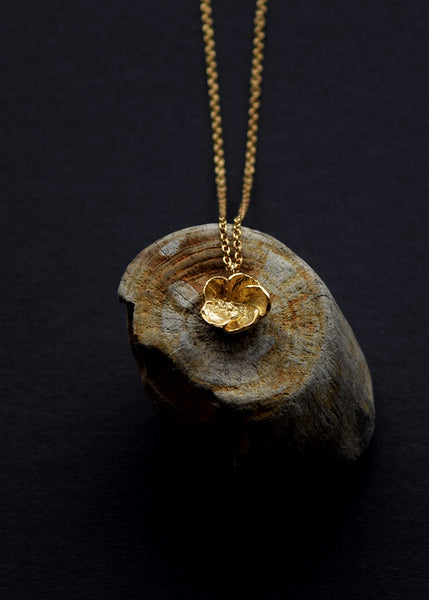 Hawthorn Blossom gold necklace displayed on natural wood by Alice Stewart Jewellery
