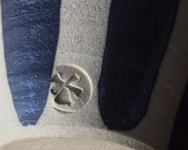 Detail of indigo and white glaze on a stoneware beaker by Windmill Pottery