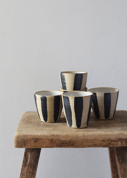 Indigo stripe stoneware beakers styled on wooden bench