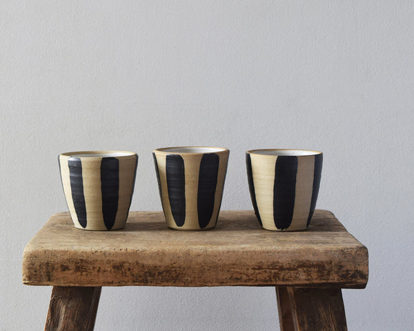 Collection of hand-thrown indigo stripe stoneware beakers by Windmill Pottery