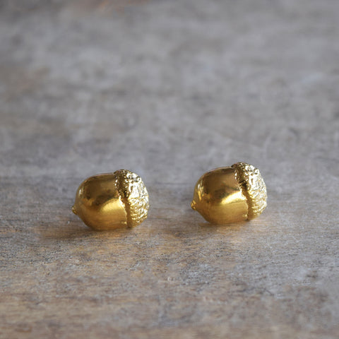 Little Acorns Mighty Oaks Grow stud earrings in gold by Alice Stewart Jewellery. Handcrafted in gold-plated solid sterling silver, these delicate gold acorn earrings measure 10mm by 10mm and have butterfly backs. Free gift wrapping and shipped using eco-friendly packaging.