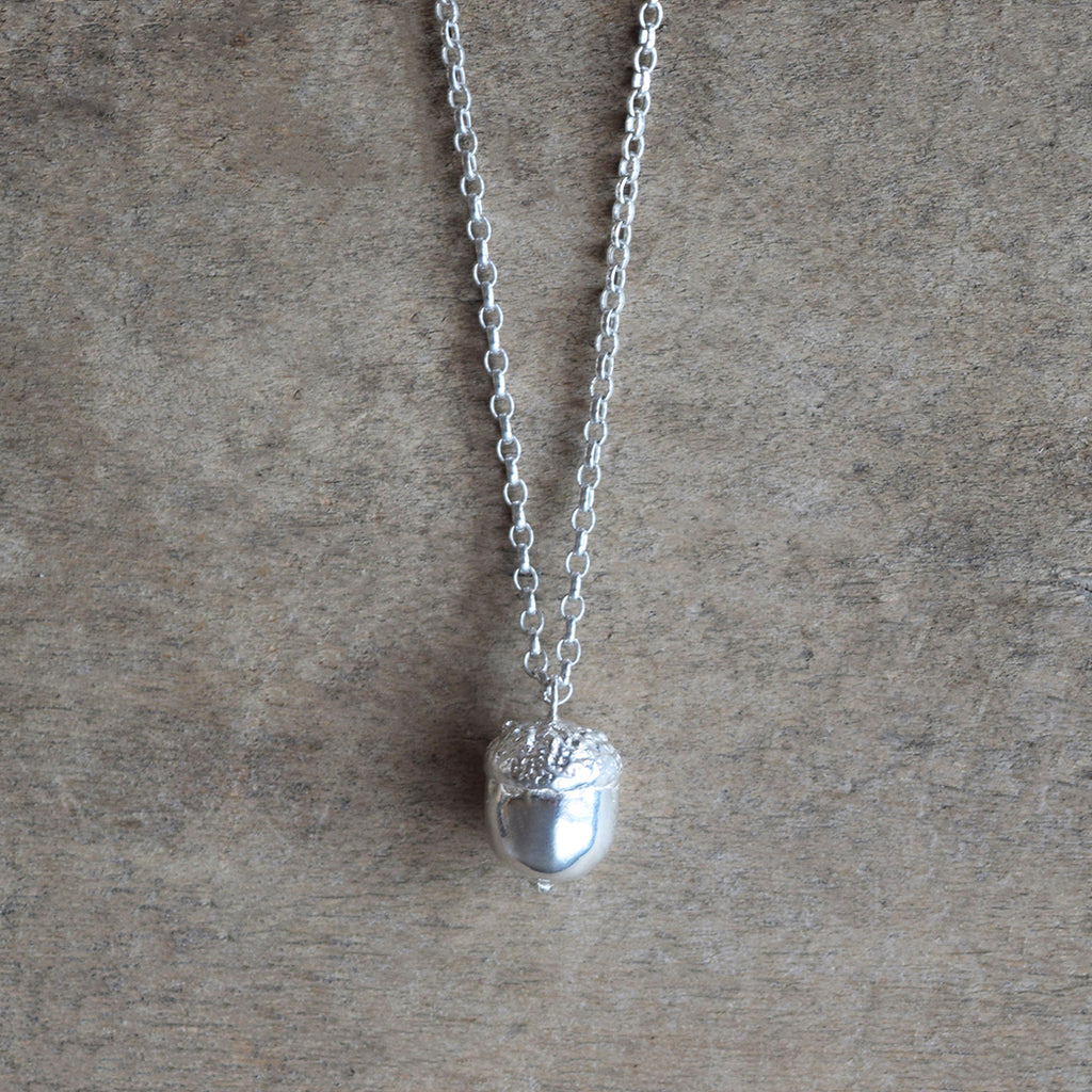 Little Acorns Mighty Oaks Grow necklace in sterling silver by Alice Stewart Jewellery. Handcrafted in solid sterling silver, this enchanting acorn pendant sits on a long adjustable sterling silver belcher chain with a bolt ring clasp. Free gift wrapping and shipped using eco-friendly packaging.