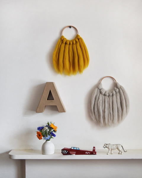 Mini woven wall hanging, designed and handcrafted in the UK from ethically sourced pure merino wool in natural. They look gorgeous in kids rooms and nurseries. 