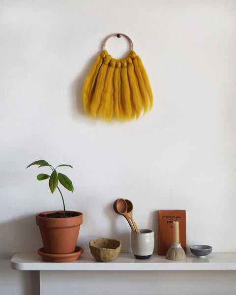 Mini woven wall hanging, designed and handcrafted in the UK from ethically sourced pure merino wool in mustard. 