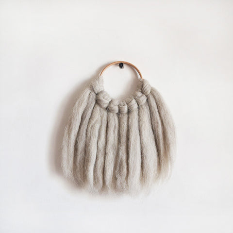 Mini woven wall hanging, designed and handcrafted in the UK from ethically sourced pure merino wool in natural. 