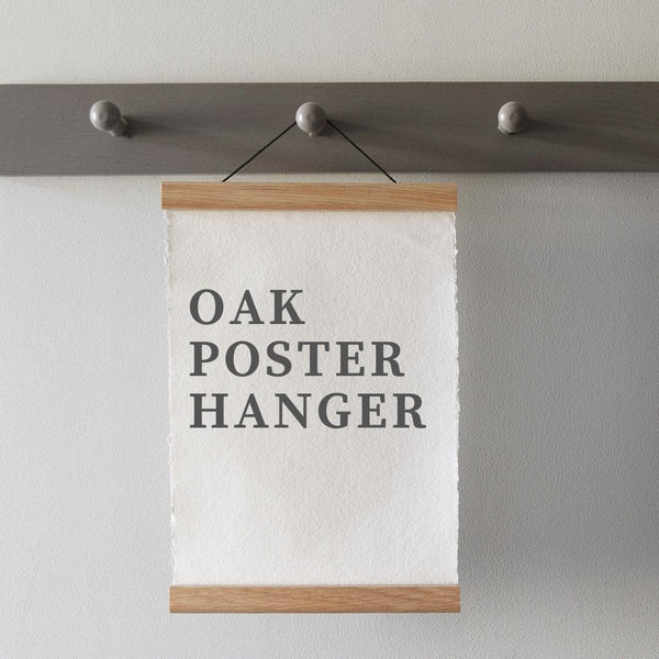 Solid oak poster hangers designed and handcrafted at a family run woodturning workshop located in rural Shropshire, England. These hangers are reusable and work perfectly with prints, posters and fabric.