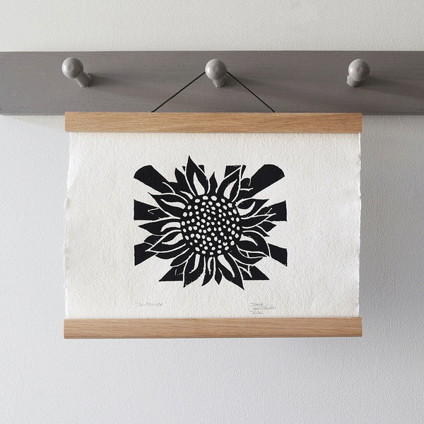 Oak picture and poster hanger displaying a botanical print on a wall