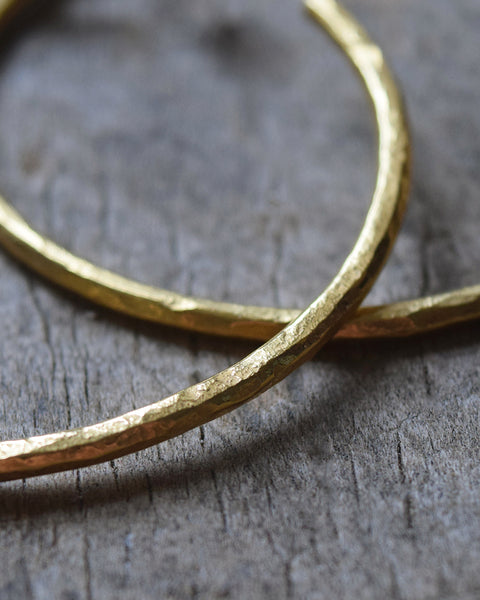 Handmade gold vermeil hoop earrings with a matt hammered surface inspired by textures found in the natural world.