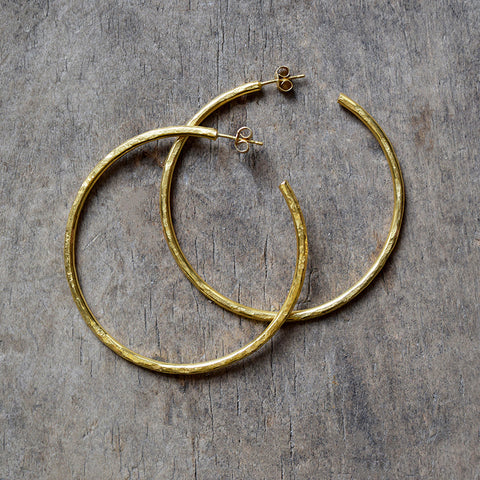 Handmade gold vermeil hoop earrings with a matt hammered surface inspired by textures found in the natural world.