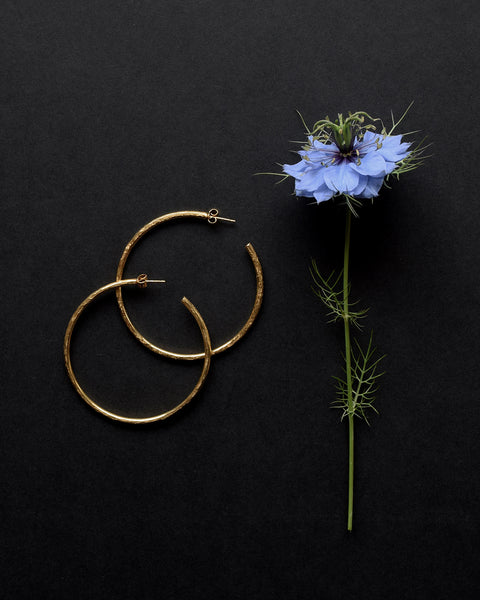 Handmade gold vermeil hoop earrings with a matt hammered surface inspired by textures found in the natural world.