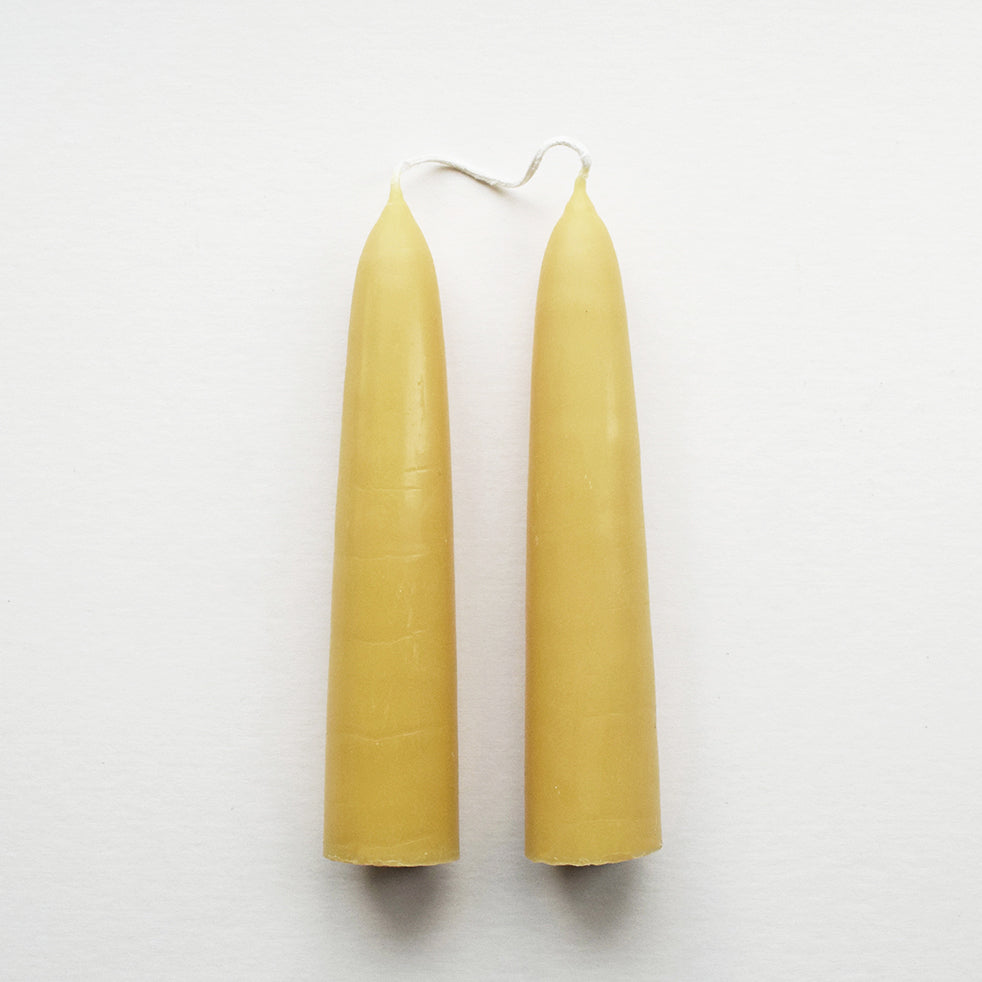 Pair of hand-dipped English beeswax Giant Stubby candles in their natural warm golden colour.