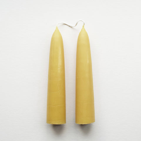Pair of hand-dipped English beeswax Giant Stubby candles in their natural warm golden colour.