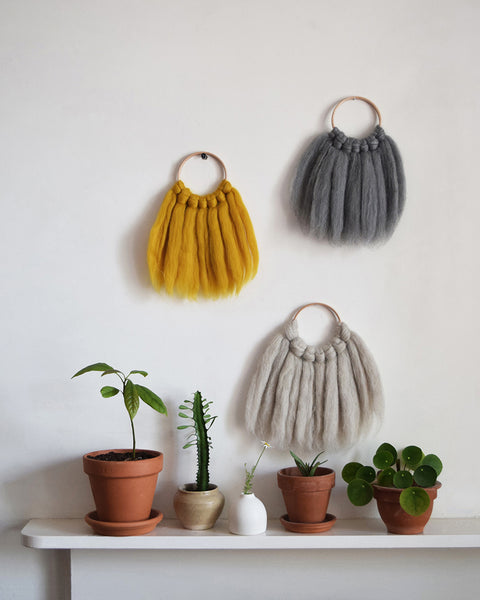 Mini woven wall hanging, designed and handcrafted in the UK from ethically sourced pure merino wool in grey. 