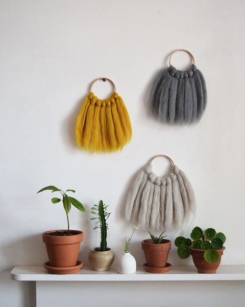 Mini woven wall hanging, designed and handcrafted in the UK from ethically sourced pure merino wool in mustard. 