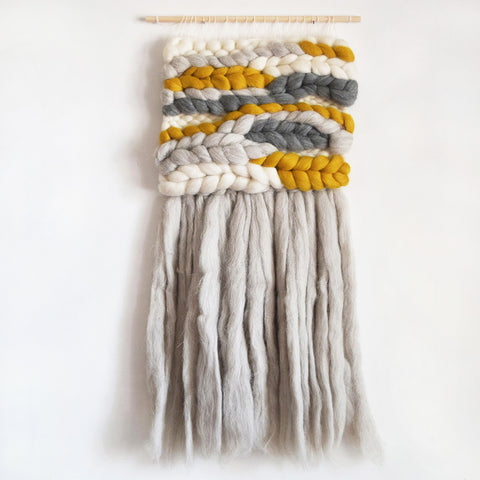 A beautiful woven wall hanging, designed and handcrafted in the UK from ethically sourced pure merino wool.