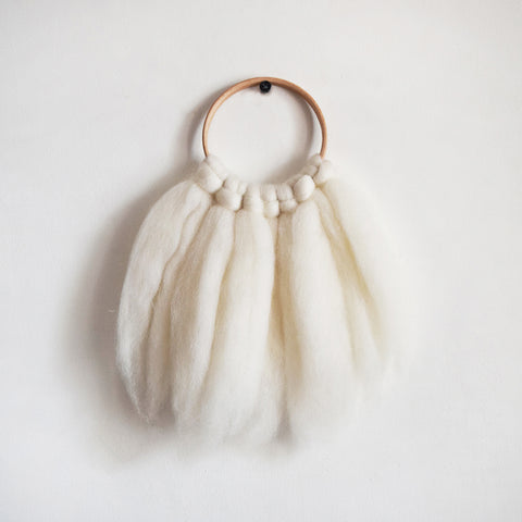 Mini woven wall hanging, designed and handcrafted in the UK from ethically sourced pure merino wool in white.