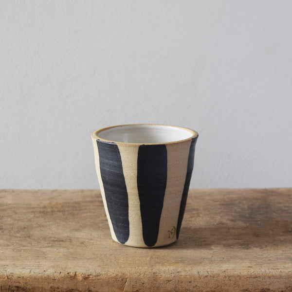Handmade Windmill Pottery ceramic beaker with a white and cobalt glaze. This beautiful beaker is perfect for coffee, water or whatever you fancy. Made in Sussex from stoneware clay by ceramicist Anna Sandberg. 