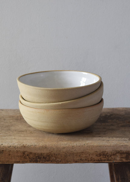 Handmade Windmill Pottery ceramic bowl with a white glaze. This beautiful bowl is small and deep, perfect for breakfast or similar. Made in Sussex from stoneware clay by ceramicist Anna Sandberg.