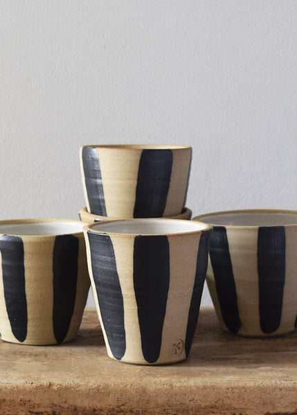 Indigo stripe stoneware beakers by Windmill Pottery on a wooden shelf