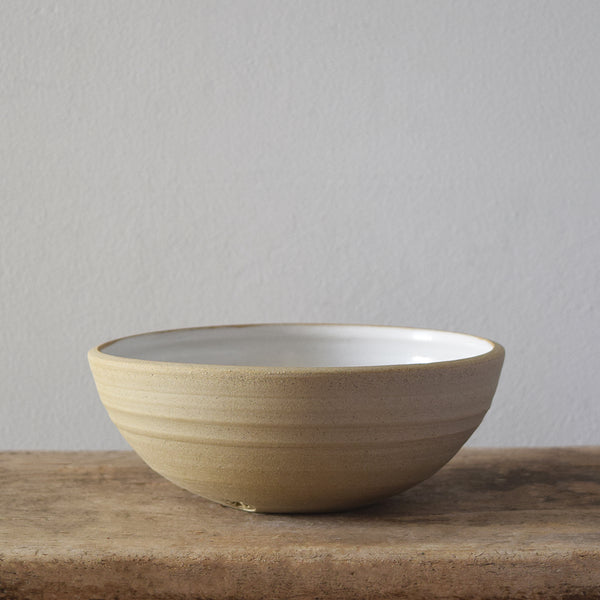 Handmade Windmill Pottery ceramic bowl with a white glaze. This beautiful bowl is small and deep, perfect for breakfast or similar. Made in Sussex from stoneware clay by ceramicist Anna Sandberg.