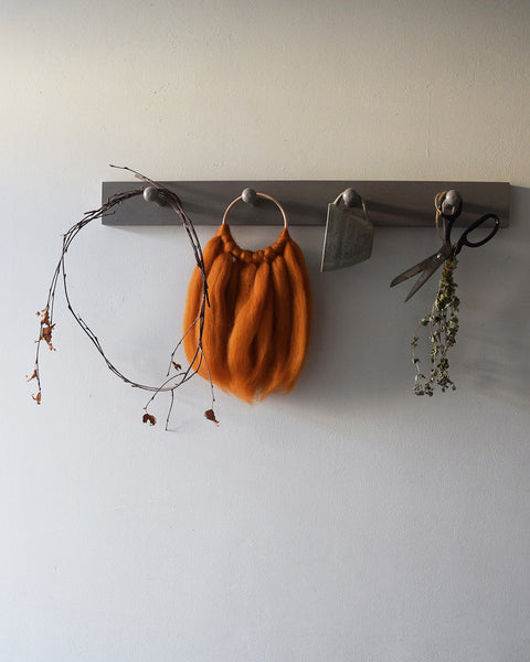 A beautiful handcrafted mini wall hanging on a wooden hoop made from ethically sourced pure merino wool. 